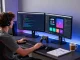 Dynamic tech workspace for slot7000 app development with vibrant coding screens and gaming equipment.