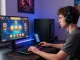 Exciting moment at a credit card casino with vibrant game graphics lighting up the player's screen and gaming setup.